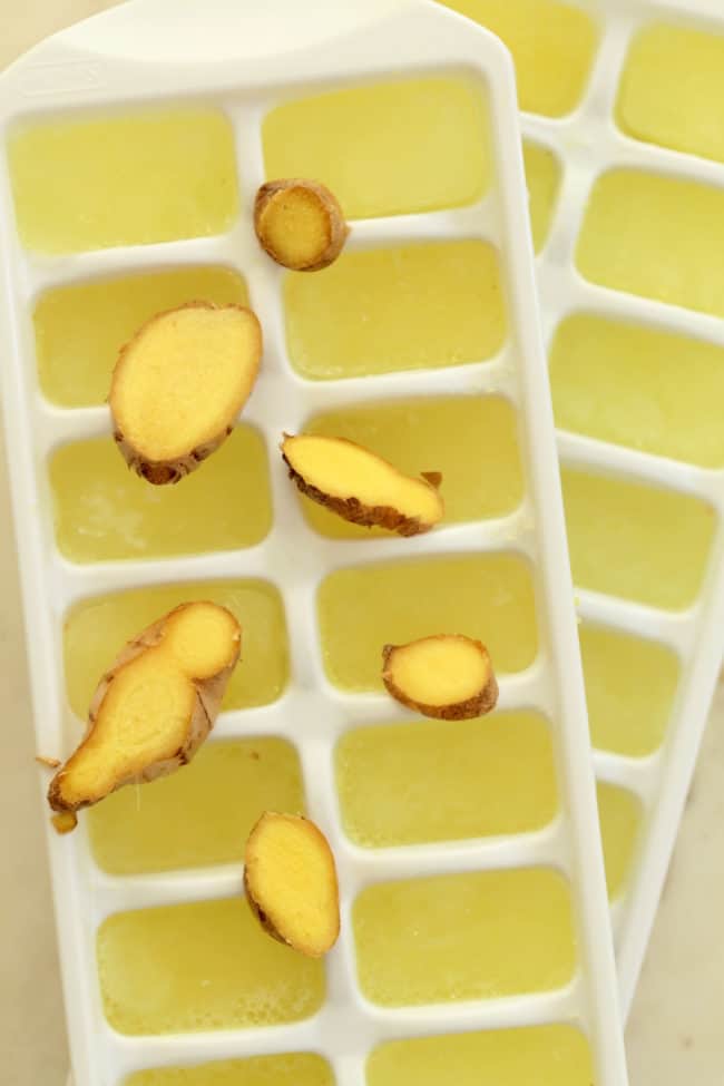 Two white trays filled with frozen flavored water.