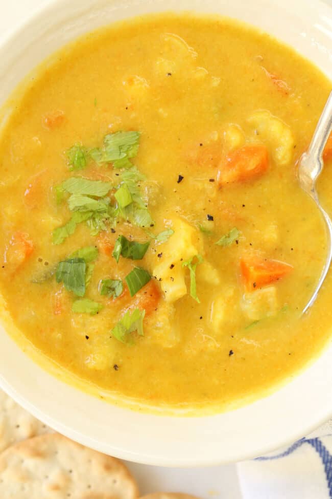 A white soup bowl filled with cauliflower chowder.