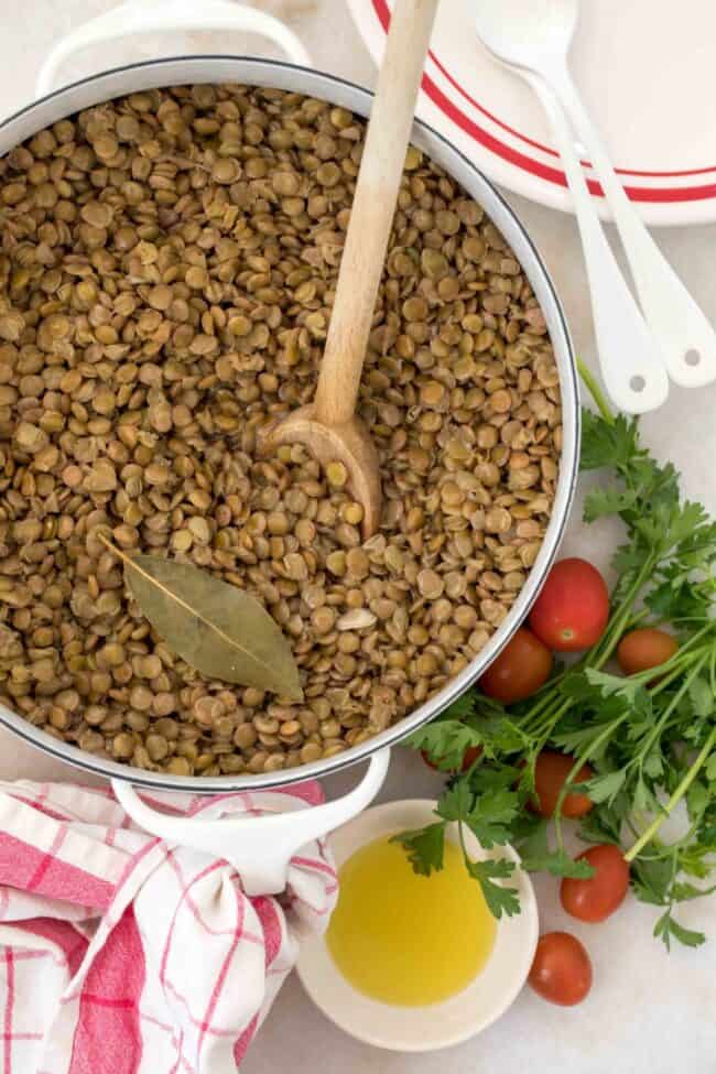 A white pot with cooked lentils.