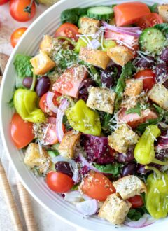 A white bowl filled with Italian salad.