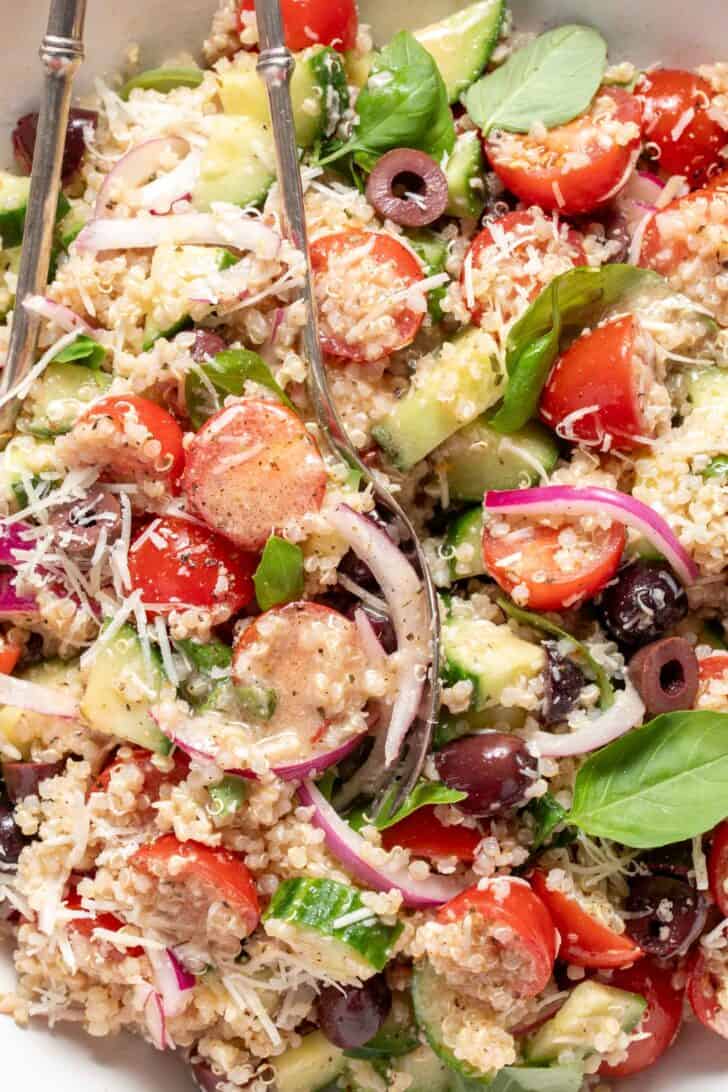 A white bowl filled with Marinated Tomato Basil Quinoa Salad.