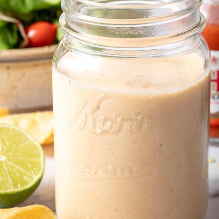 A clear glass mason jar filled with Buffalo Ranch Dressing.