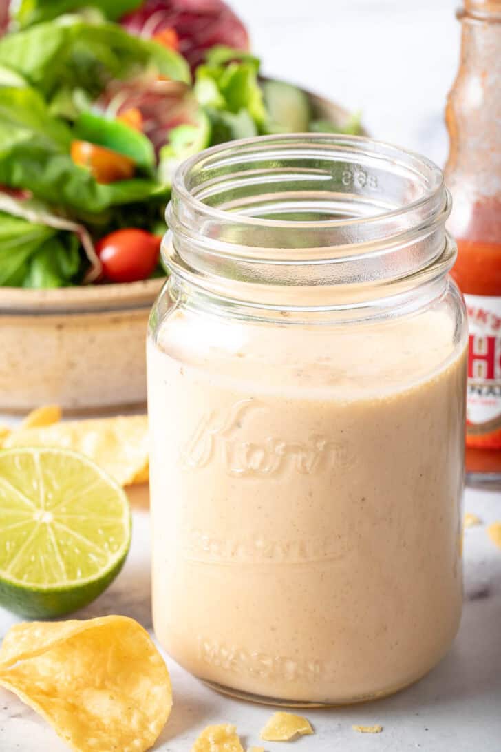 A clear glass mason jar filled with Buffalo Ranch Salad Dressing.