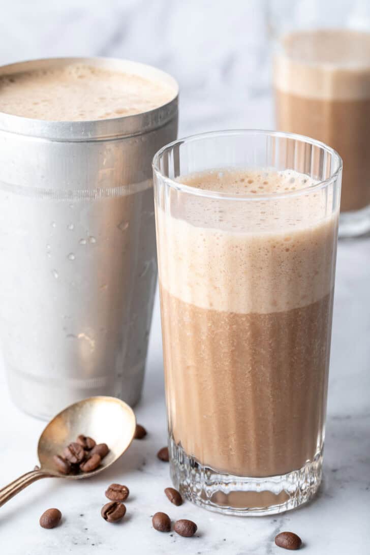 A clear drinking glass filled with Coffee Smoothie.