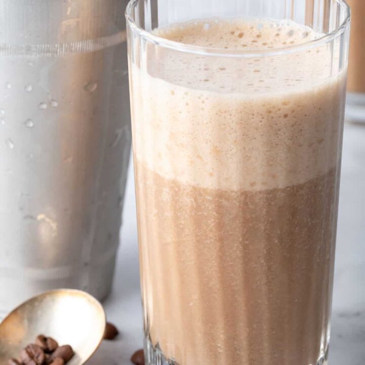 A clear drinking glass filled with Coffee Smoothie.