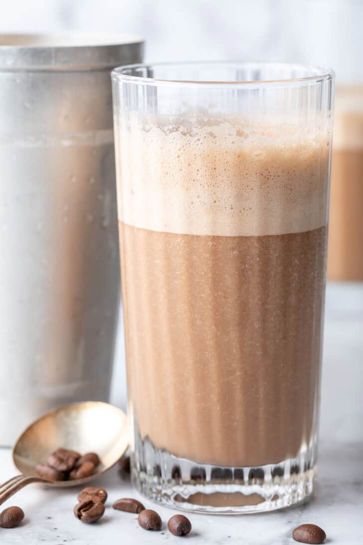 A clear drinking glass filled with Coffee Smoothie.