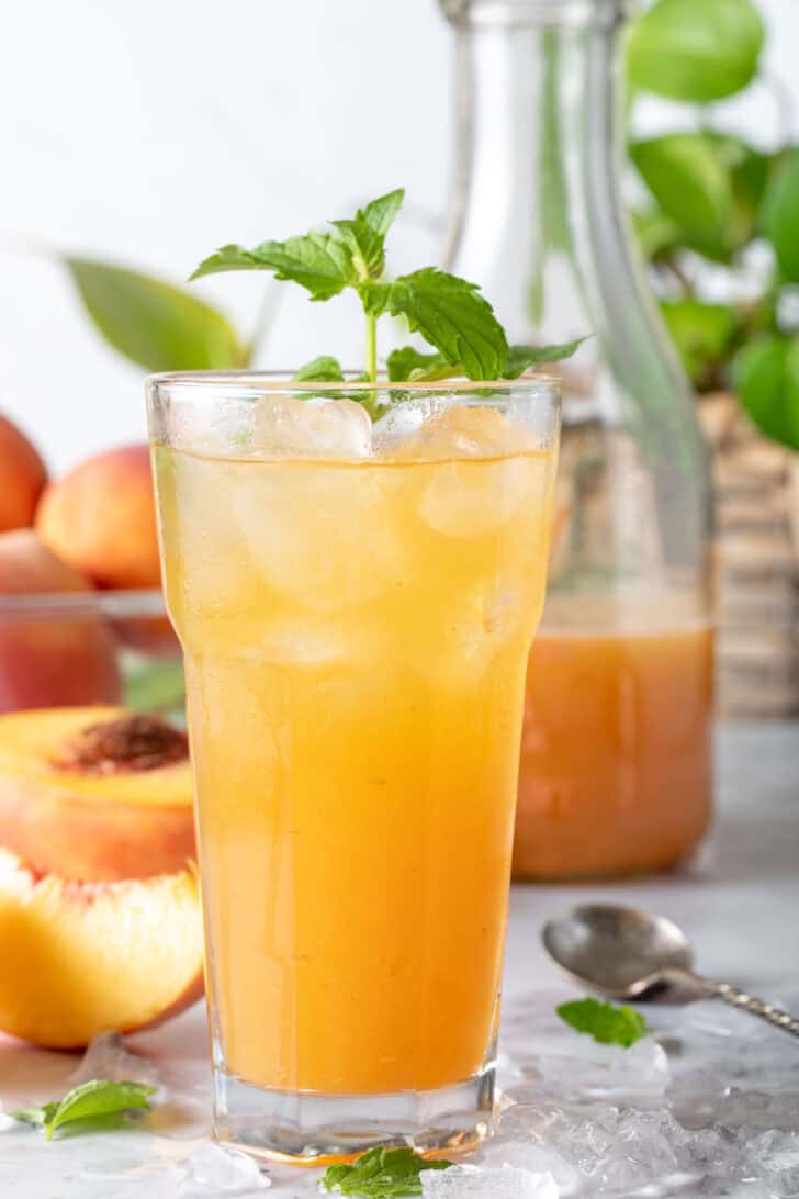 A clear drinking glass filled with a fruit drink.