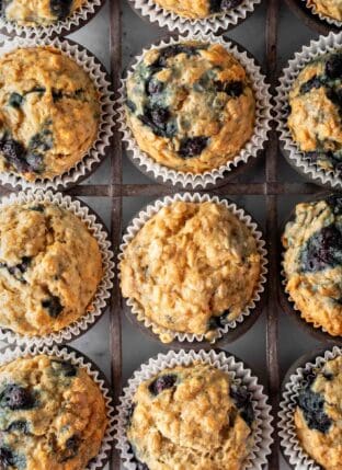 A vintage metal muffin tin filled with Blueberry Oatmeal Muffins.