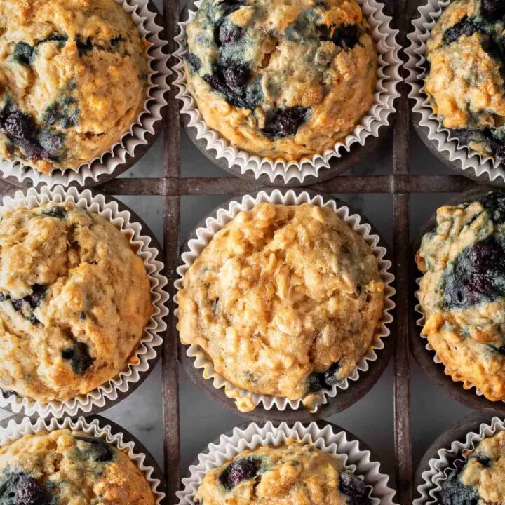 A vintage metal muffin tin filled with Blueberry Oatmeal Muffins.