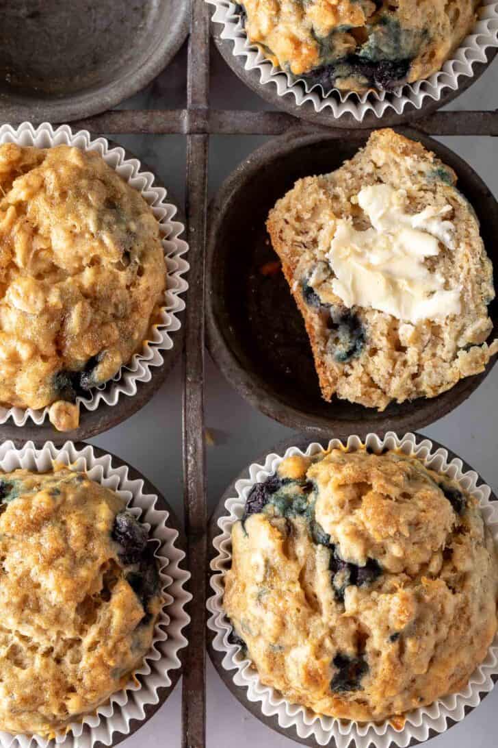 A vintage metal tin filled with baked treats.