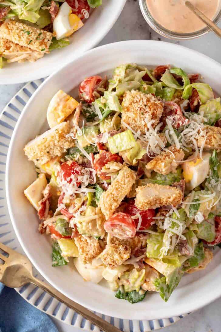 A white bowl filled with Crispy Chicken Salad.