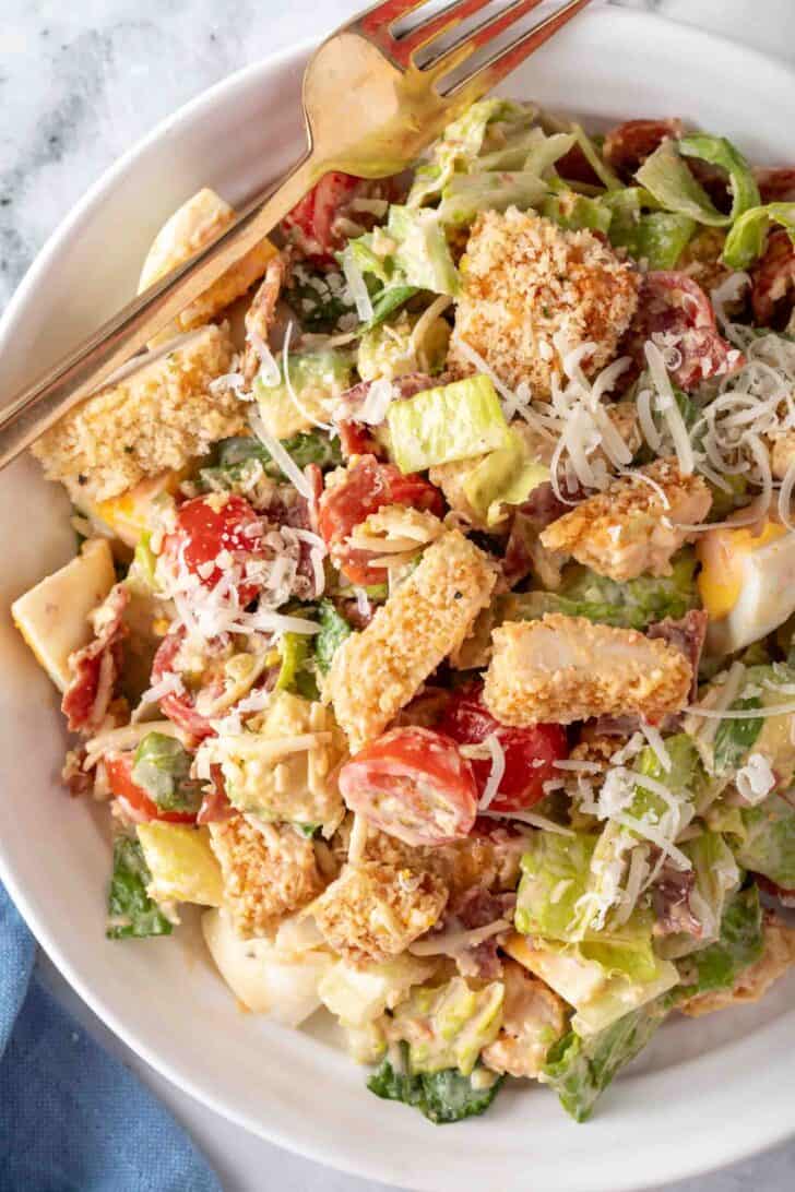 A white bowl filled with Crispy Chicken Salad.