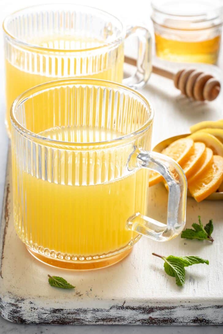 Two clear tea mugs filled with Apple Cider Vinegar Tea.