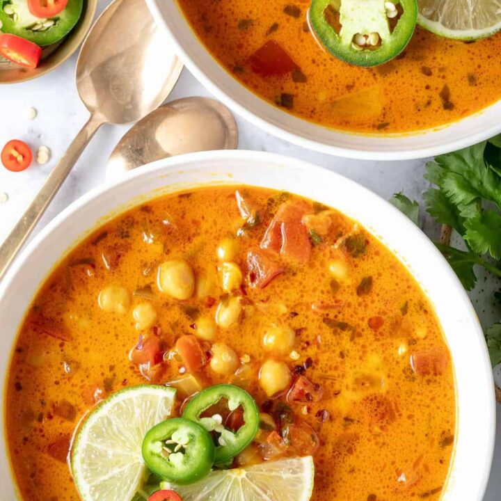 Two white bowls filled with Chickpea Coconut Curry Soup.