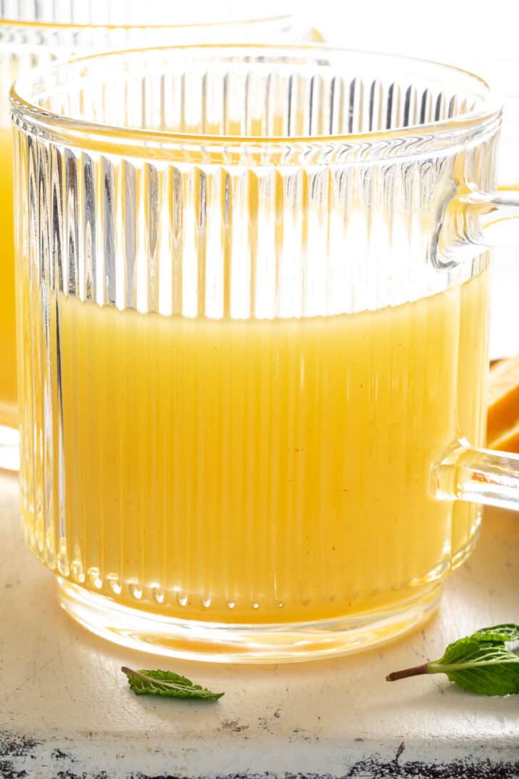 A clear glass mug filled with ACV tea.