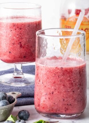 Two clear glasses filled with fruit Green Tea Smoothie.