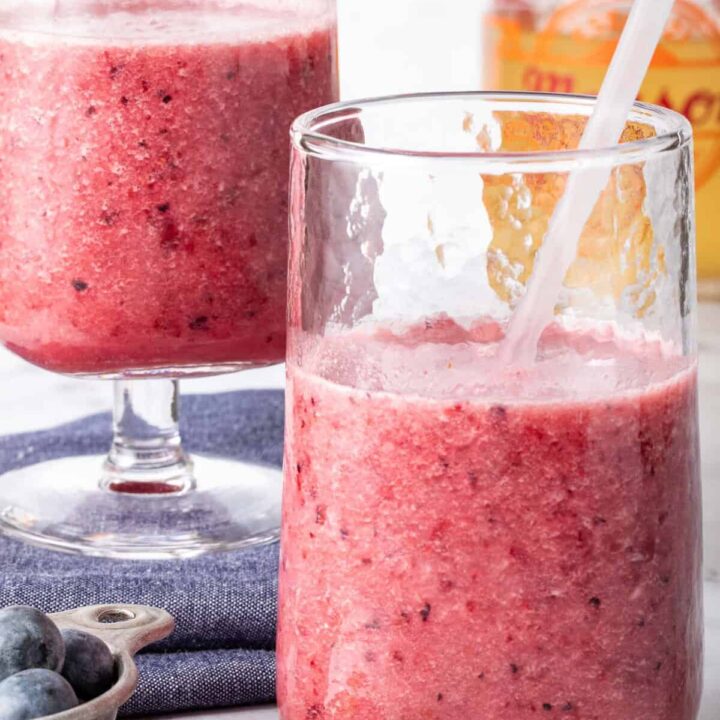 Two clear glasses filled with fruit Green Tea Smoothie.