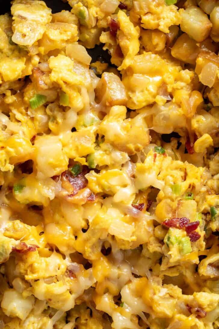 A skillet filled with fried hash browns and eggs.