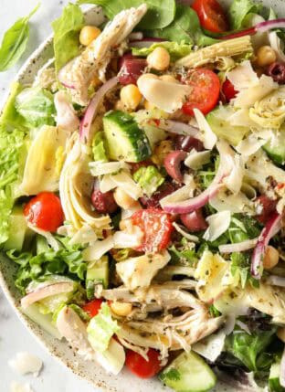 A white bowl filled with Mediterranean Chicken Salad.