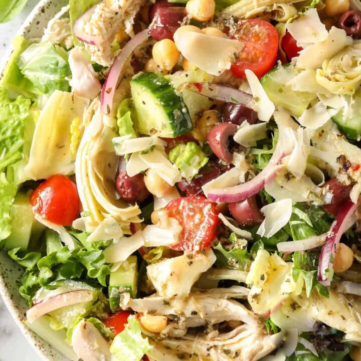 A white bowl filled with Mediterranean Chicken Salad.