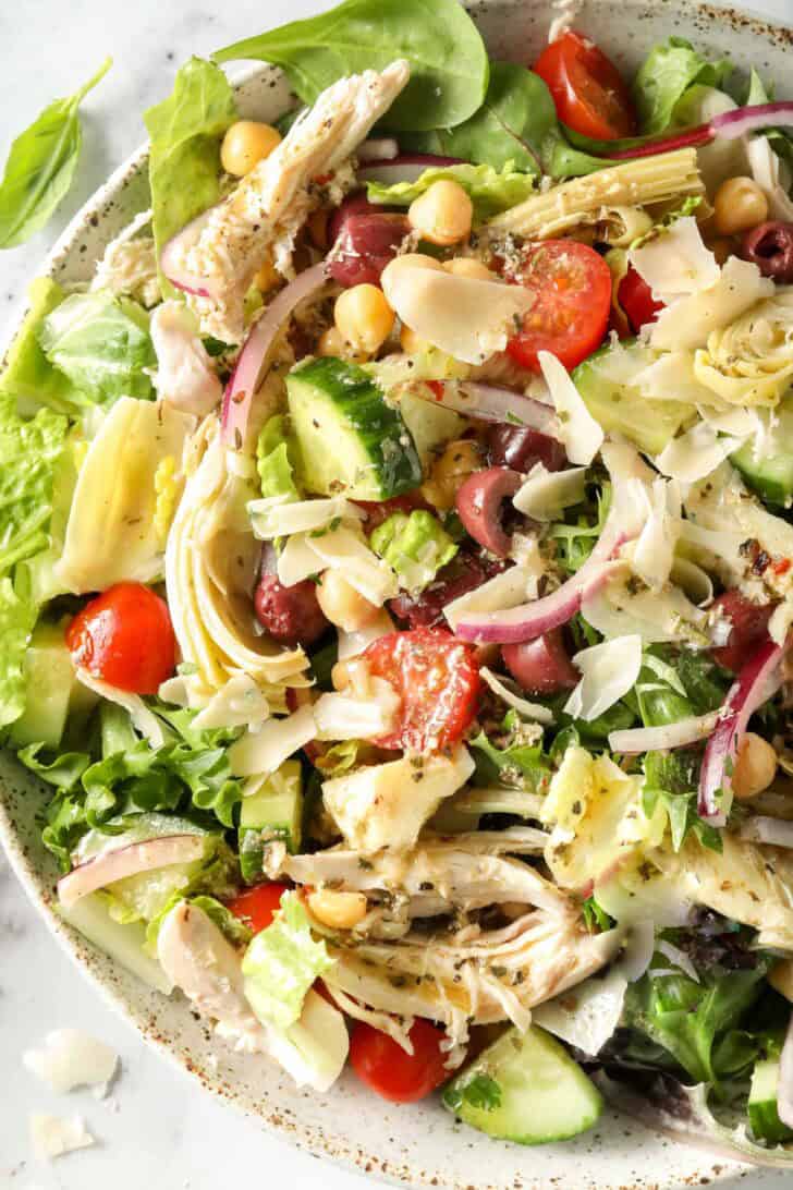 A white bowl filled with Mediterranean Chicken Salad.