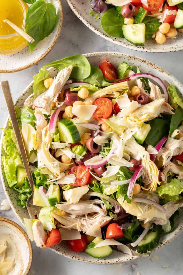 A white bowl filled with Chicken Mediterranean Salad.